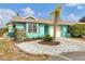 Quaint teal home with a one-car garage and nicely landscaped front yard at 255 Boundary Blvd # 105, Rotonda West, FL 33947