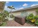 Relaxing hot tub area with tropical landscaping and wood deck at 255 Boundary Blvd # 105, Rotonda West, FL 33947