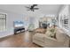 Open living area with a beige sectional sofa and a view of the kitchen at 255 Boundary Blvd # 105, Rotonda West, FL 33947