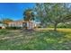Spacious backyard with lush lawn, large trees, and privacy at 2888 Myakka Creek Ct., Port Charlotte, FL 33953