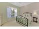Bedroom with a metal bed frame, dresser and window at 2888 Myakka Creek Ct., Port Charlotte, FL 33953