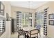 Charming breakfast nook with a table and chairs, and black and white curtains at 2888 Myakka Creek Ct., Port Charlotte, FL 33953