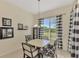 Bright breakfast nook with black and white checkered curtains at 2888 Myakka Creek Ct., Port Charlotte, FL 33953