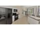 Modern kitchen with black appliances and white cabinets at 2888 Myakka Creek Ct., Port Charlotte, FL 33953