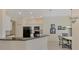 Bright kitchen with granite countertops, white cabinets, and black appliances at 2888 Myakka Creek Ct., Port Charlotte, FL 33953