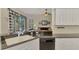Kitchen with granite countertops, white cabinets, and a view to the living room at 2888 Myakka Creek Ct., Port Charlotte, FL 33953
