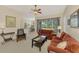 Spacious living room with sectional sofa and view of kitchen at 2888 Myakka Creek Ct., Port Charlotte, FL 33953