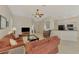 Open living room with kitchen view, sectional sofa, and hardwood floors at 2888 Myakka Creek Ct., Port Charlotte, FL 33953