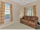 Home office featuring a brown leather couch and two windows at 2888 Myakka Creek Ct., Port Charlotte, FL 33953