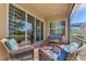 Relaxing screened porch with wicker furniture and view of backyard at 2888 Myakka Creek Ct., Port Charlotte, FL 33953