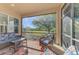 Relaxing screened porch with wicker furniture and view of backyard at 2888 Myakka Creek Ct., Port Charlotte, FL 33953