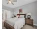 Comfortable bedroom with a queen bed, nightstands and ceiling fan at 305 Daylily Blvd, Nokomis, FL 34275