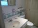 Bathroom featuring a sink, toilet, and decorative border at 320 Lasayette Ne Dr, Port Charlotte, FL 33952