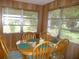 Bright dining area with wood table and chairs, and wood paneled walls at 320 Lasayette Ne Dr, Port Charlotte, FL 33952