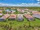 Aerial view of a luxury home community with houses, pools, and lush landscaping at 3283 Osprey Ln, Port Charlotte, FL 33953