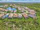 Aerial view of a neighborhood with houses and a lake at 3283 Osprey Ln, Port Charlotte, FL 33953