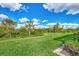 Spacious backyard with lush green grass and natural landscape at 3283 Osprey Ln, Port Charlotte, FL 33953