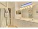 Double vanity bathroom with modern light fixture at 3283 Osprey Ln, Port Charlotte, FL 33953