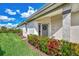 Front door entrance with wreath, landscaping, and stone pathway at 3283 Osprey Ln, Port Charlotte, FL 33953