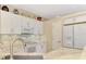 Modern kitchen with white cabinets, marble countertops, and stainless steel appliances at 3283 Osprey Ln, Port Charlotte, FL 33953
