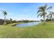 Serene backyard with pond view and lush landscaping at 3310 Bay Ridge Way, Port Charlotte, FL 33953