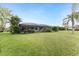 Expansive grassy backyard with view of house at 3310 Bay Ridge Way, Port Charlotte, FL 33953