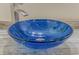 Close-up of a modern blue glass vessel sink at 3310 Bay Ridge Way, Port Charlotte, FL 33953