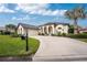 Front view of home, showcasing landscaping and driveway at 3310 Bay Ridge Way, Port Charlotte, FL 33953