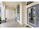 Inviting front porch with gray door and tiled flooring at 3310 Bay Ridge Way, Port Charlotte, FL 33953