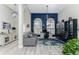 Home office with wood floors, built-in shelving and comfortable seating at 3310 Bay Ridge Way, Port Charlotte, FL 33953