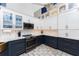 Modern kitchen with white and navy blue cabinets and quartz countertops at 3310 Bay Ridge Way, Port Charlotte, FL 33953