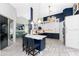 Modern kitchen with white and blue cabinets, quartz countertops, and breakfast bar at 3310 Bay Ridge Way, Port Charlotte, FL 33953