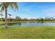 Waterfront property with lush green lawn and palm trees at 3310 Bay Ridge Way, Port Charlotte, FL 33953