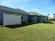 Landscaped backyard with white fence and AC unit at 380 Hoffer St, Port Charlotte, FL 33953
