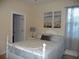 Charming bedroom with white wooden bed frame and two-toned bedding at 380 Hoffer St, Port Charlotte, FL 33953