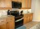 Modern kitchen featuring granite countertops and stainless steel appliances at 380 Hoffer St, Port Charlotte, FL 33953