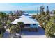 Aerial view of a beach house with ocean views and tropical landscaping at 396 N Gulf Blvd, Placida, FL 33946