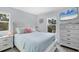 Bright bedroom with a queen-size bed, window, and dresser at 396 N Gulf Blvd, Placida, FL 33946