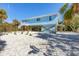 Elevated light blue house exterior with tropical landscaping at 396 N Gulf Blvd, Placida, FL 33946