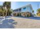 Elevated beach house exterior with screened porch and tropical landscaping at 396 N Gulf Blvd, Placida, FL 33946
