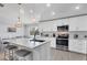 Modern kitchen with white cabinets, large island, and stainless steel appliances at 396 N Gulf Blvd, Placida, FL 33946