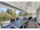 Screened porch with dining table and seating, offering water views at 396 N Gulf Blvd, Placida, FL 33946