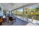 Relaxing screened porch with outdoor seating, overlooking lush tropical landscape at 396 N Gulf Blvd, Placida, FL 33946