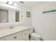 Clean bathroom with white vanity, toilet and a mirrored medicine cabinet at 4260 Placida Rd # 24B, Englewood, FL 34224