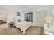 Bright bedroom with a double bed and sliding door to balcony at 4260 Placida Rd # 24B, Englewood, FL 34224