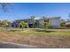 Condo building with palm trees in front and grassy area at 4260 Placida Rd # 24B, Englewood, FL 34224