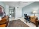 Home office with built-in shelving, desk and view to hallway at 4410 Warren Ave # 503, Port Charlotte, FL 33953