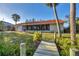 Backyard oasis with covered patio, lush landscaping, and private dock access at 4696 Pompano St, Placida, FL 33946