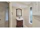 Clean bathroom with vanity, shower, and window at 4696 Pompano St, Placida, FL 33946