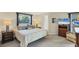Main bedroom with king-size bed, two nightstands, and a relaxing armchair at 4696 Pompano St, Placida, FL 33946